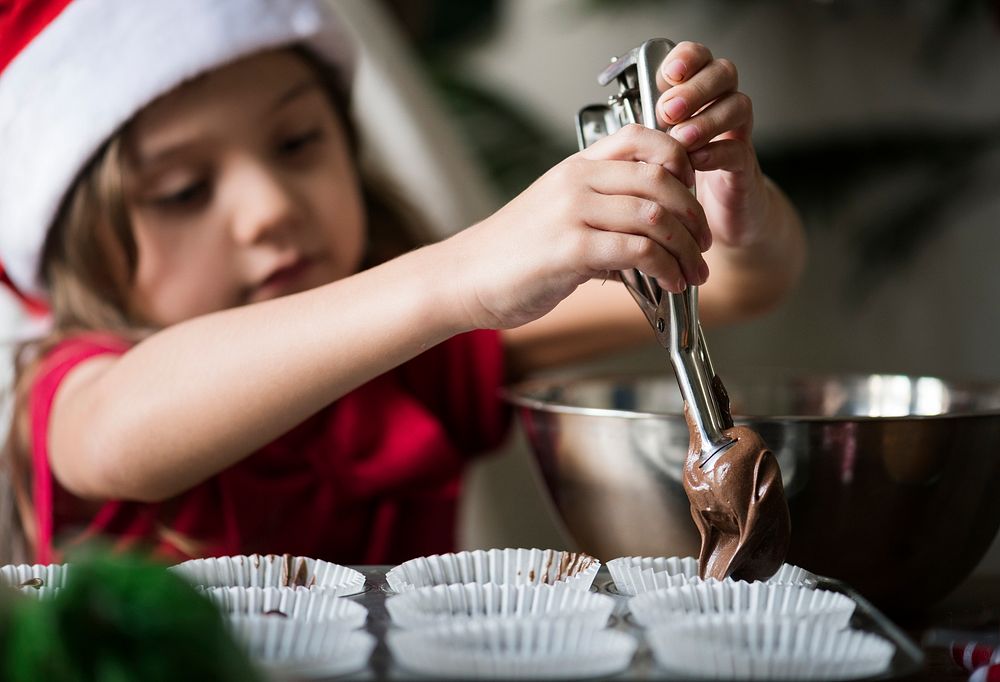 Little girl making chocolate cupcakes