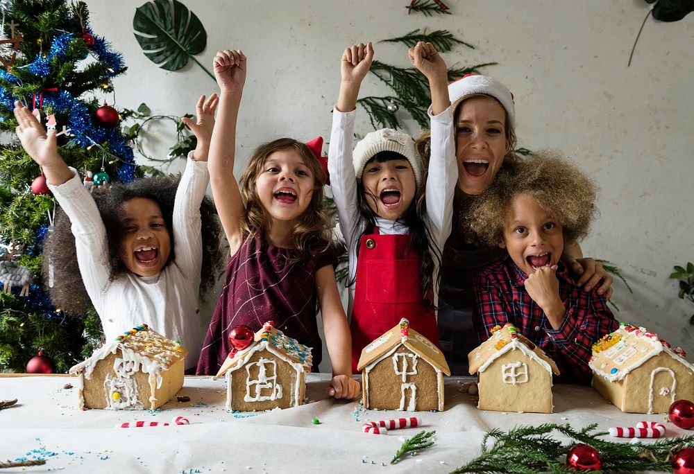 Happy kids with their gingerbread houses