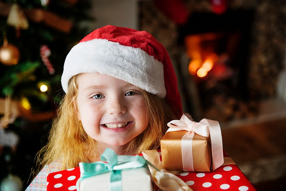 Little girl receiving Christmas presents