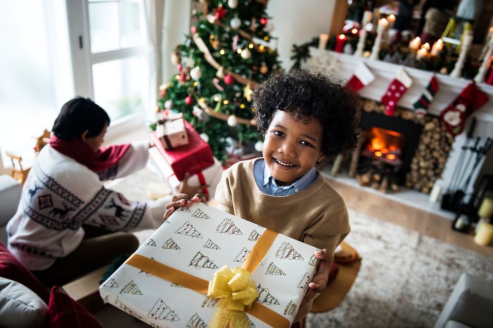 Young kid holding a Christmas present