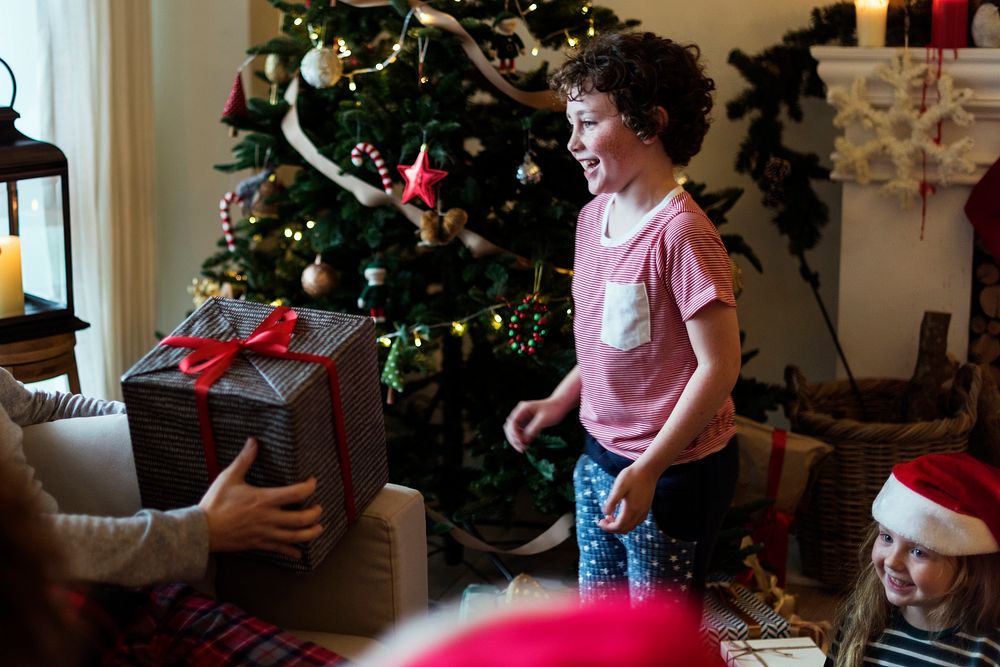 Young Caucasian boy Christmas present | Free Photo - rawpixel