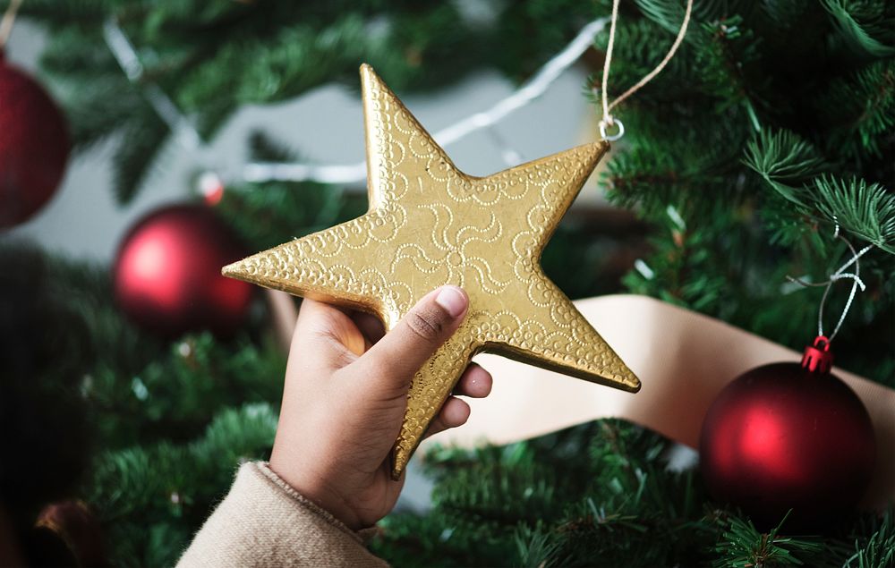 Little kid holding a Christmas star
