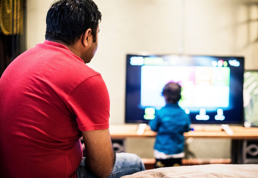 Young Indian boy watching television