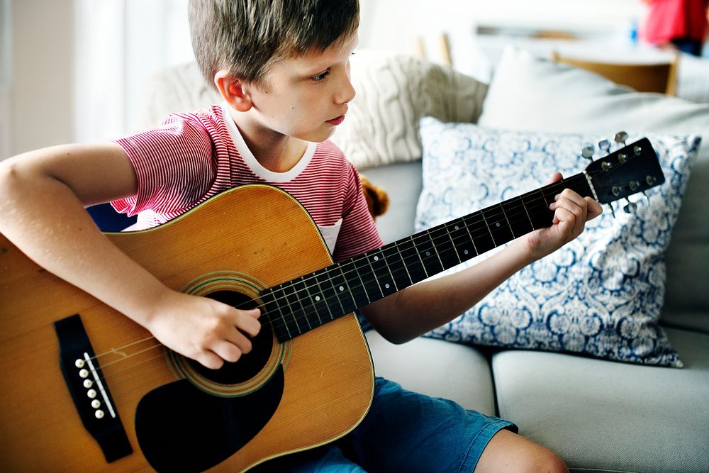 Young boy playing guitar