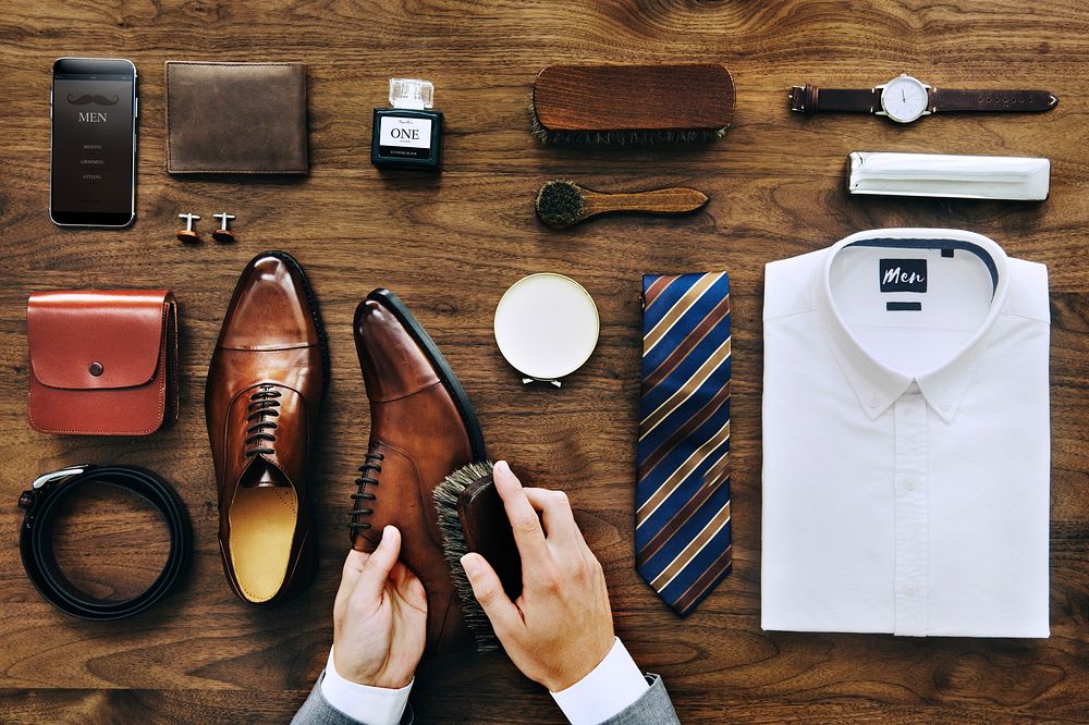 Flatlay view of a businessman cleaning his shoes and his belongings
