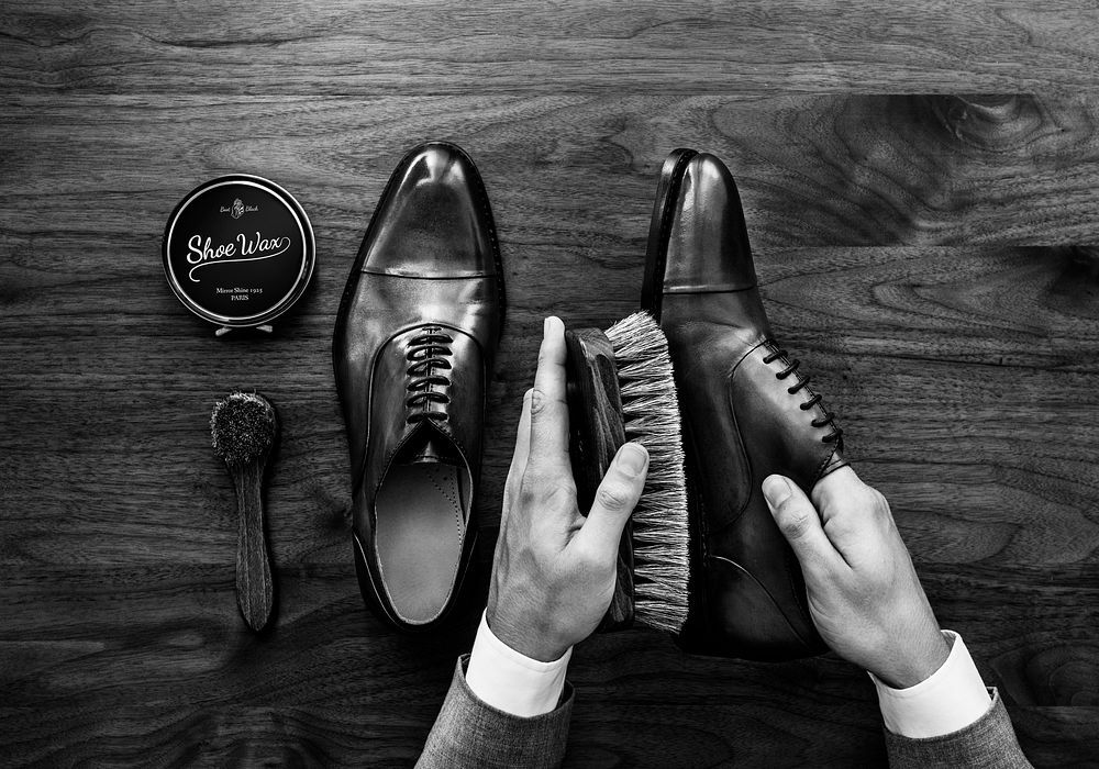 Businessman cleaning his shoes