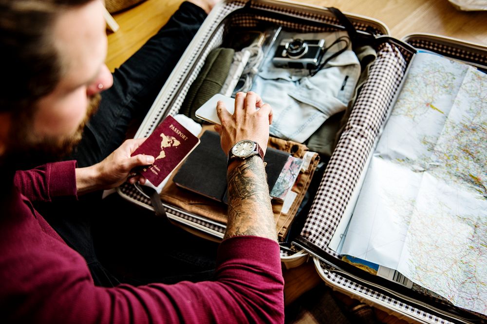 Caucasian man packing luggage for a trip