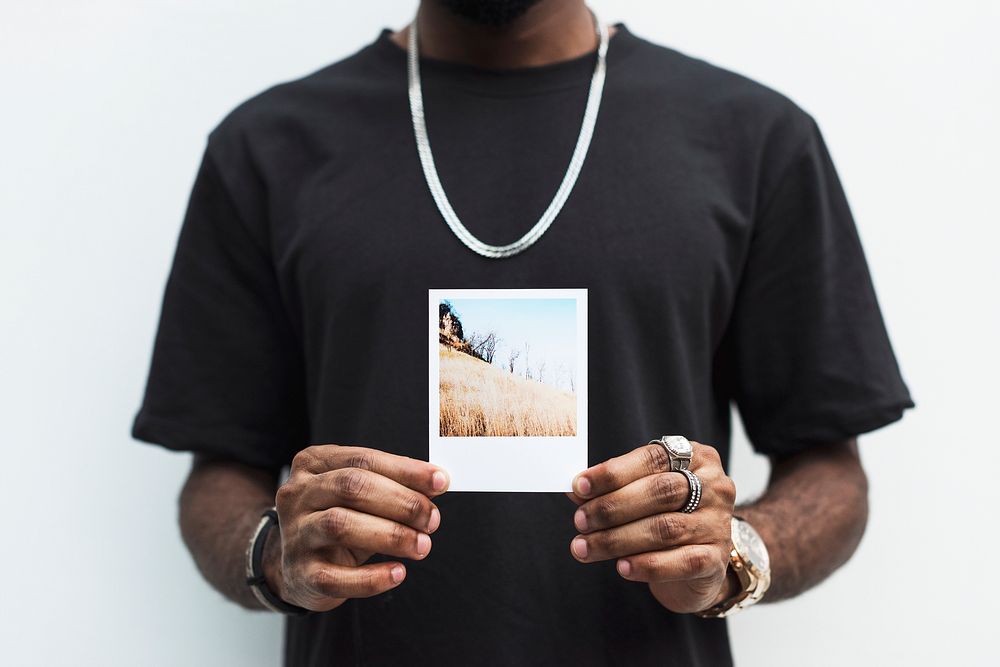 African man holding a picture