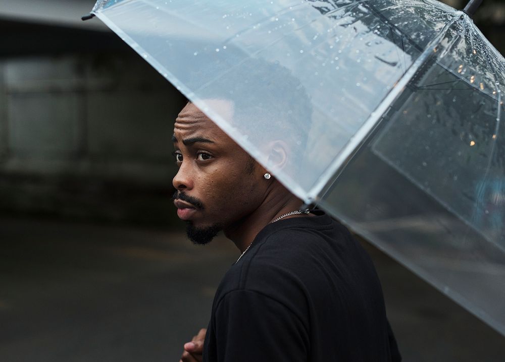 African descent man in an umbrella