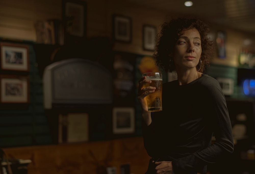 Woman having a beer at a bar