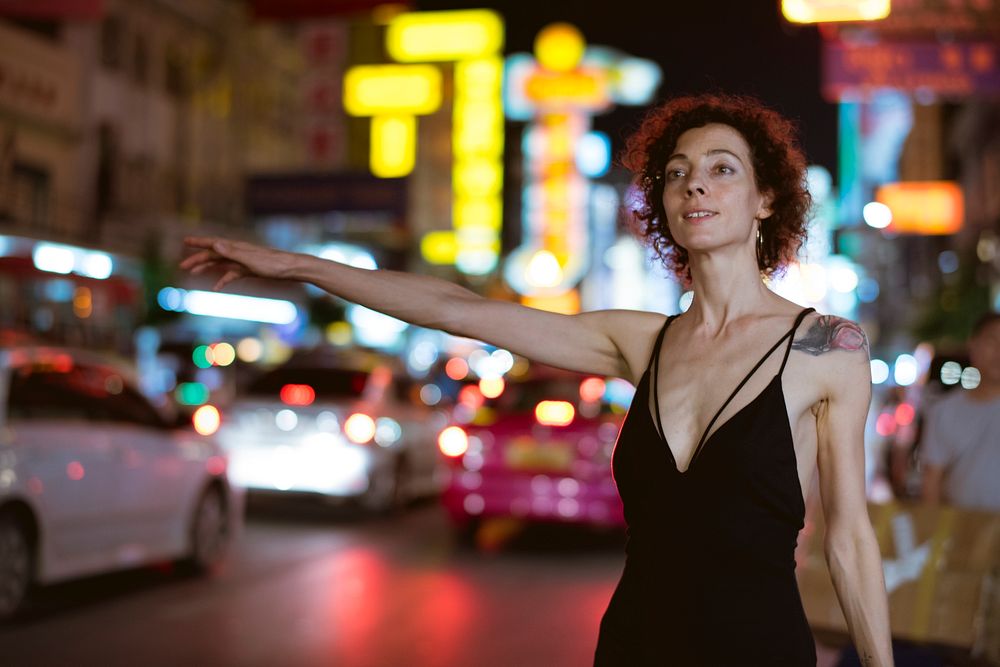 Woman hailing a cab on a the street