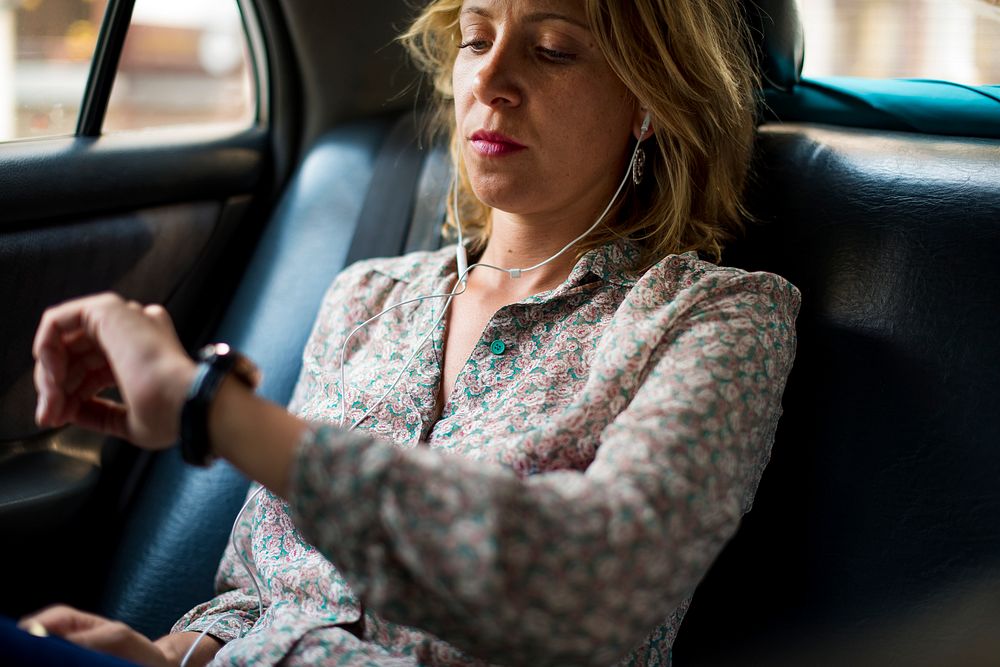 Blond woman sitting in a taxi