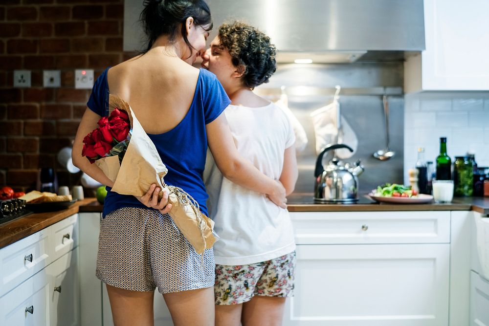 Lesbian couple cooking in the kitchen together