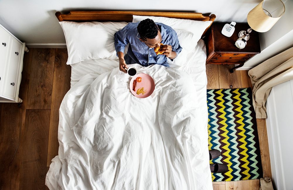 Man in bed having a breakfast in bed