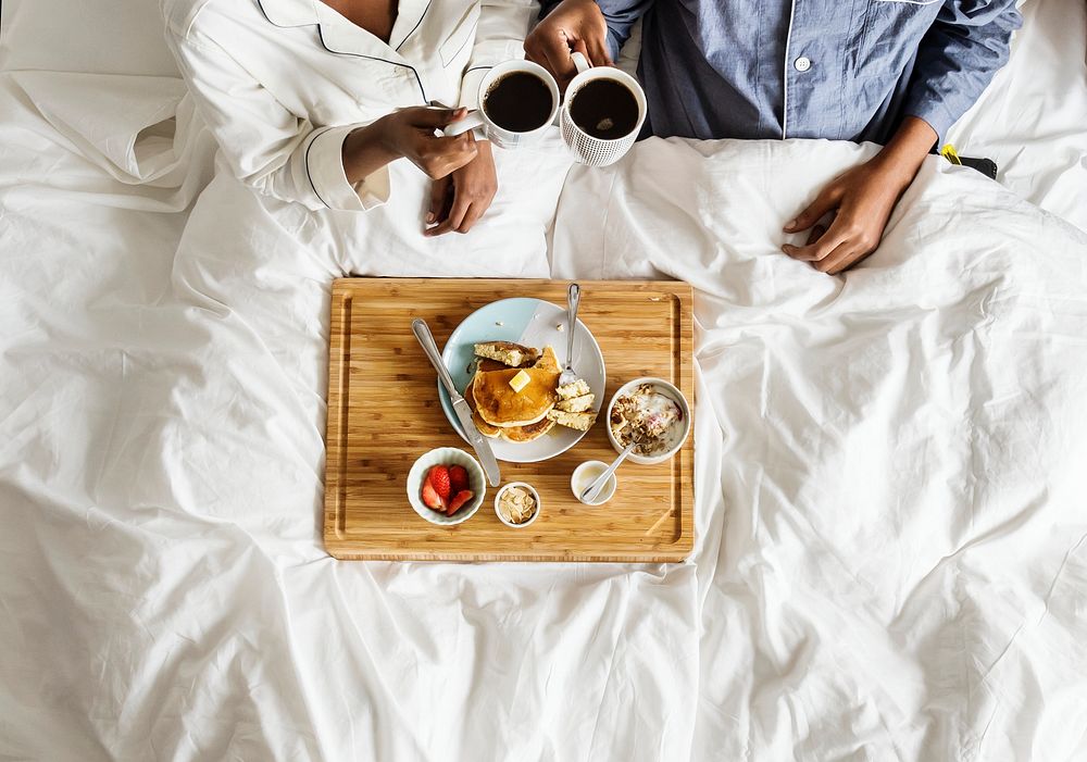 African American couple in bed having a breakfast in bed