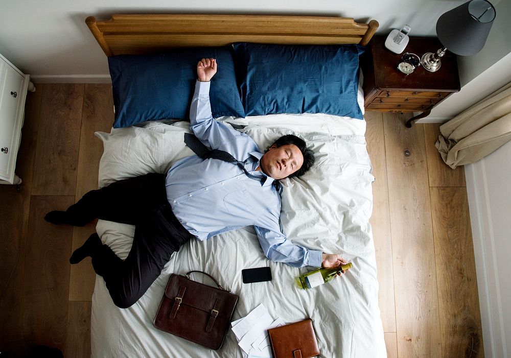 Drunk Asian business man falling asleep as soon as he came back home