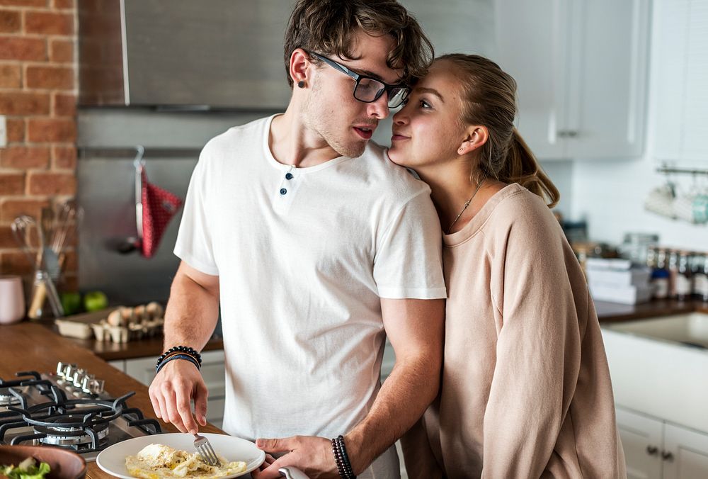 Caucasian couple cooking in the kitchen together