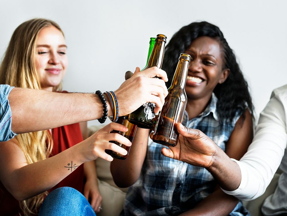 Group of diverse friends drinking beers together