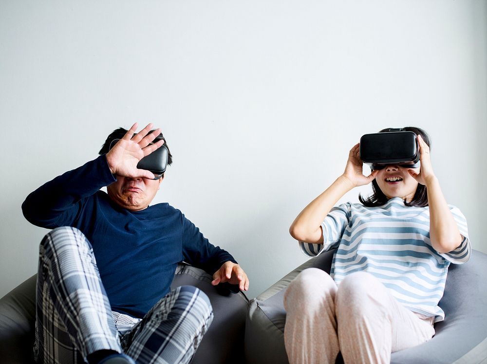 Asian couple experiencing virtual reality with VR headset