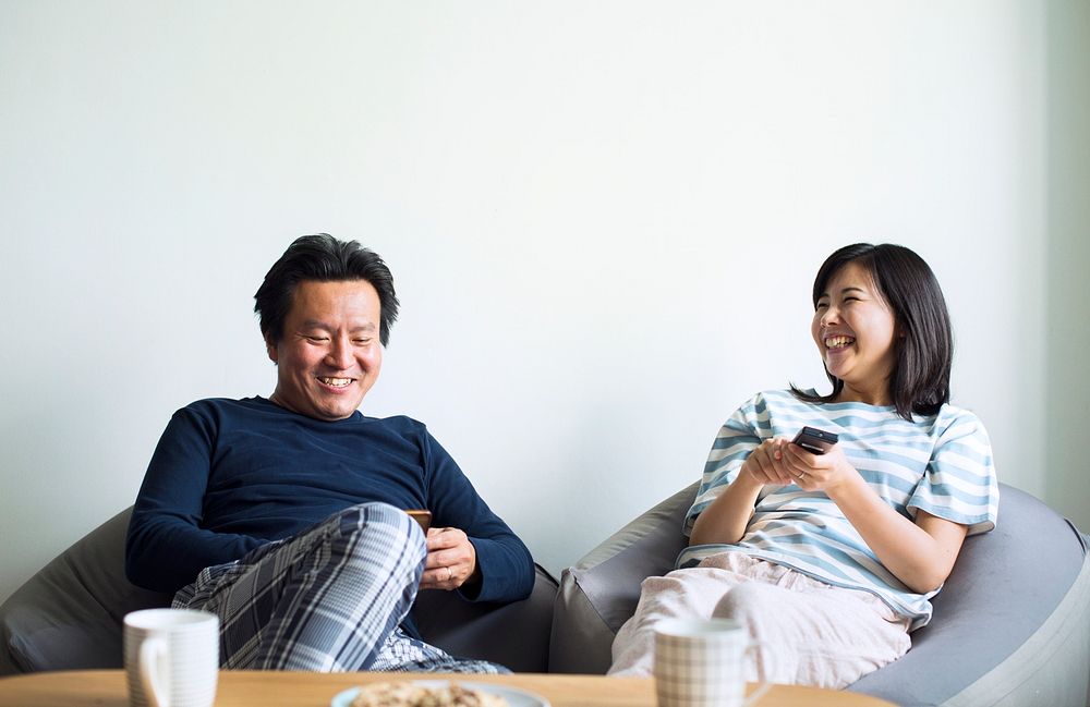 Asian couple watching movie at home together