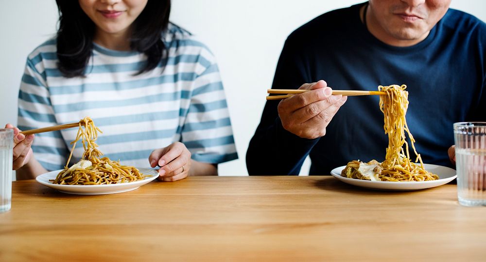 Asian couple eating noodles