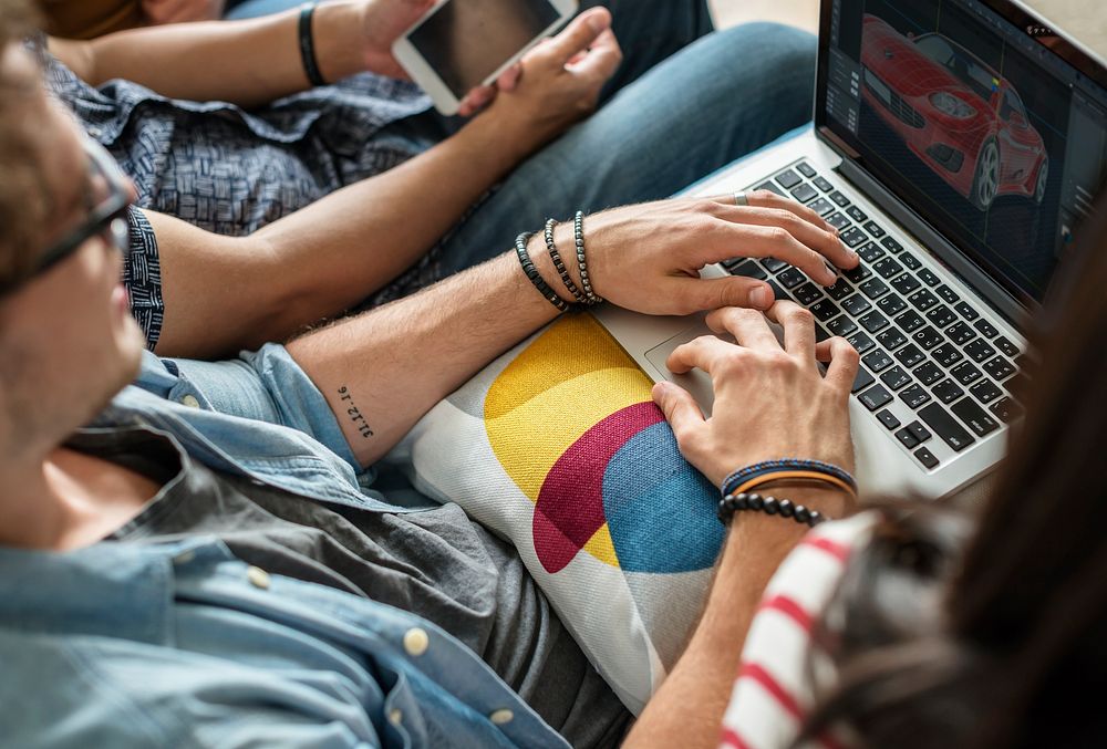 Group of diverse friends using digital devices