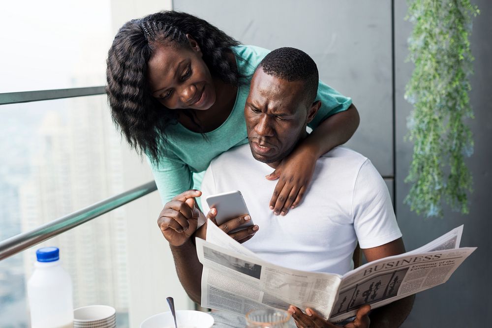 Black couple using mobile phone