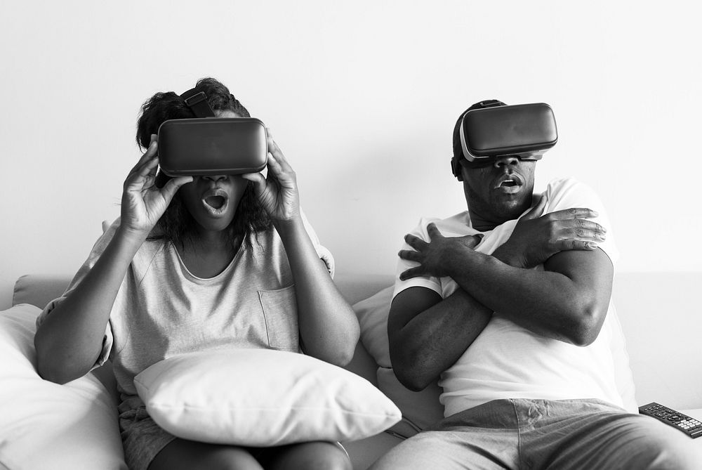 Black couple experiencing virtual reality with VR headset