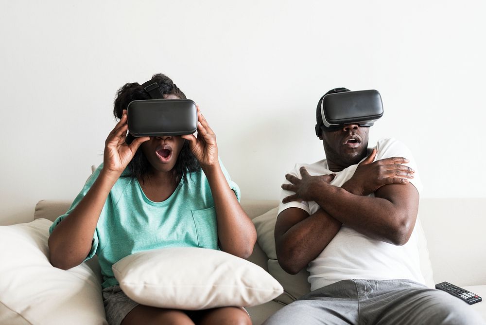 Black couple experiencing virtual reality with VR headset