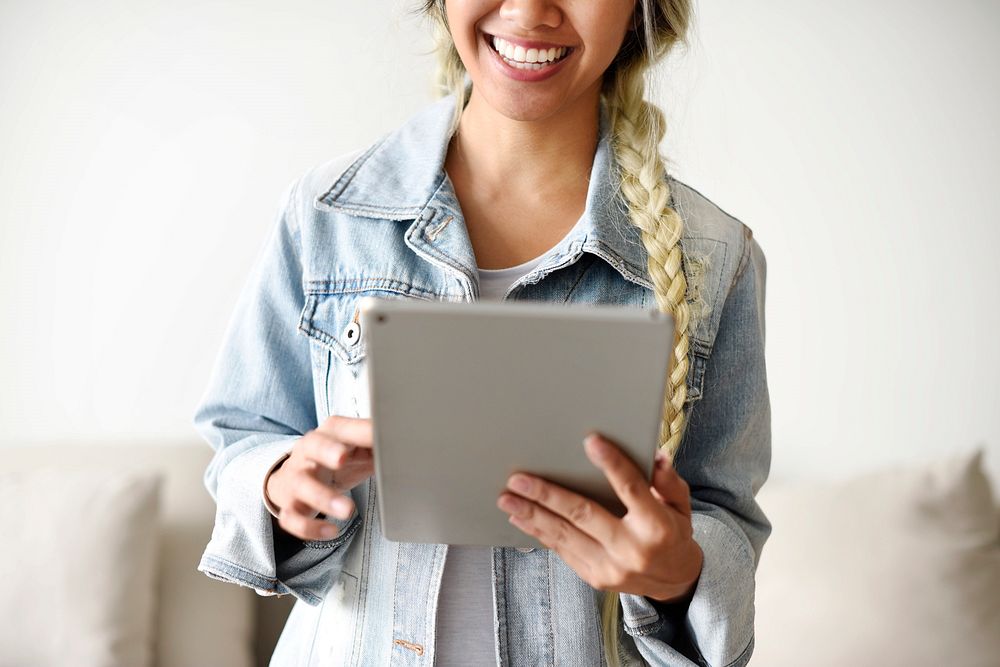 Smiling woman using a digital tablet