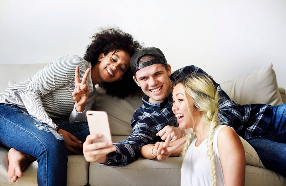 Friends taking a selfie together at home