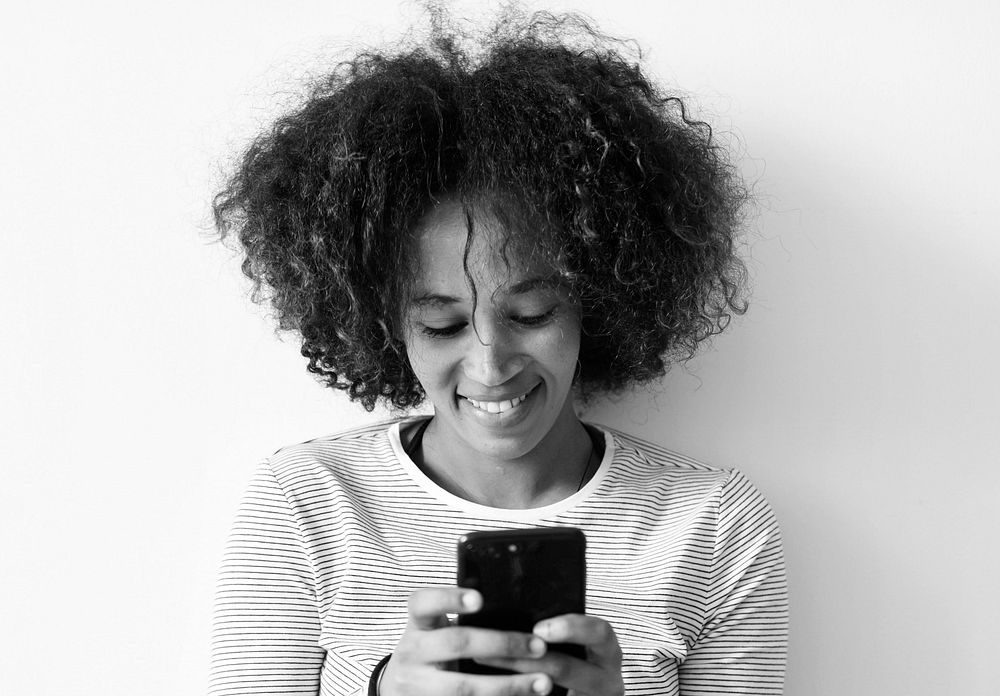 Smiling woman using a smartphone