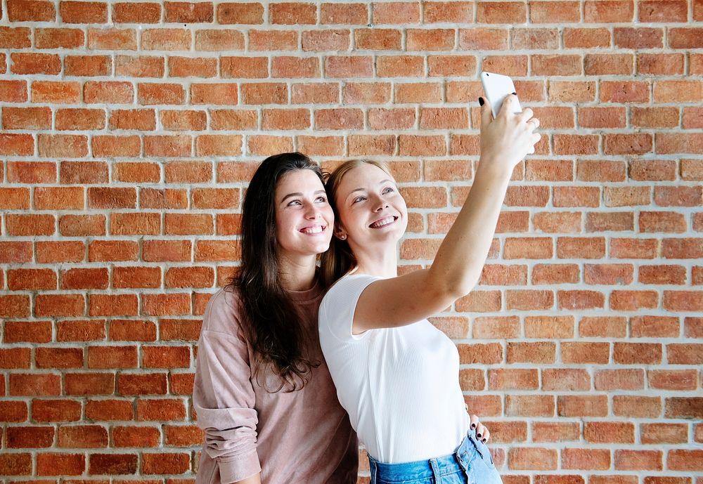 Smiling female friends taking a selfie
