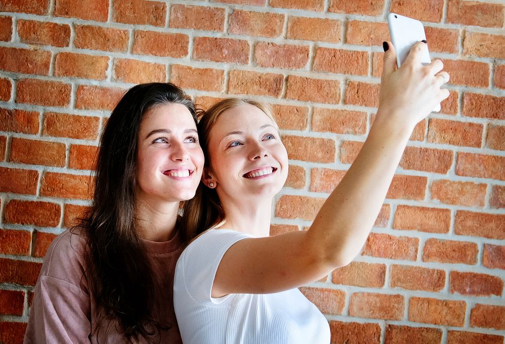 Smiling female friends taking a selfie