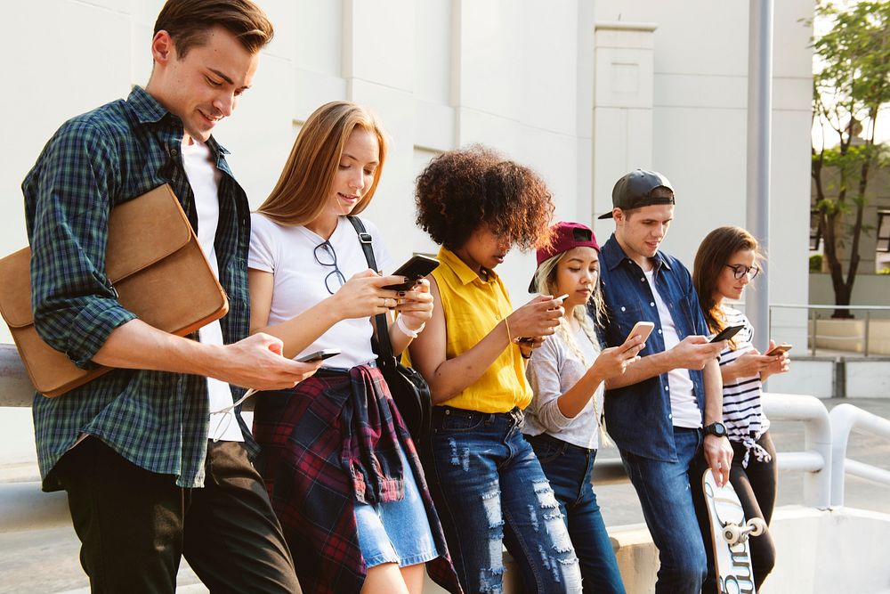 Millennials using smartphones outdoors