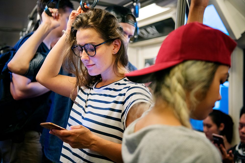 Young woman using a smartphone on the subway
