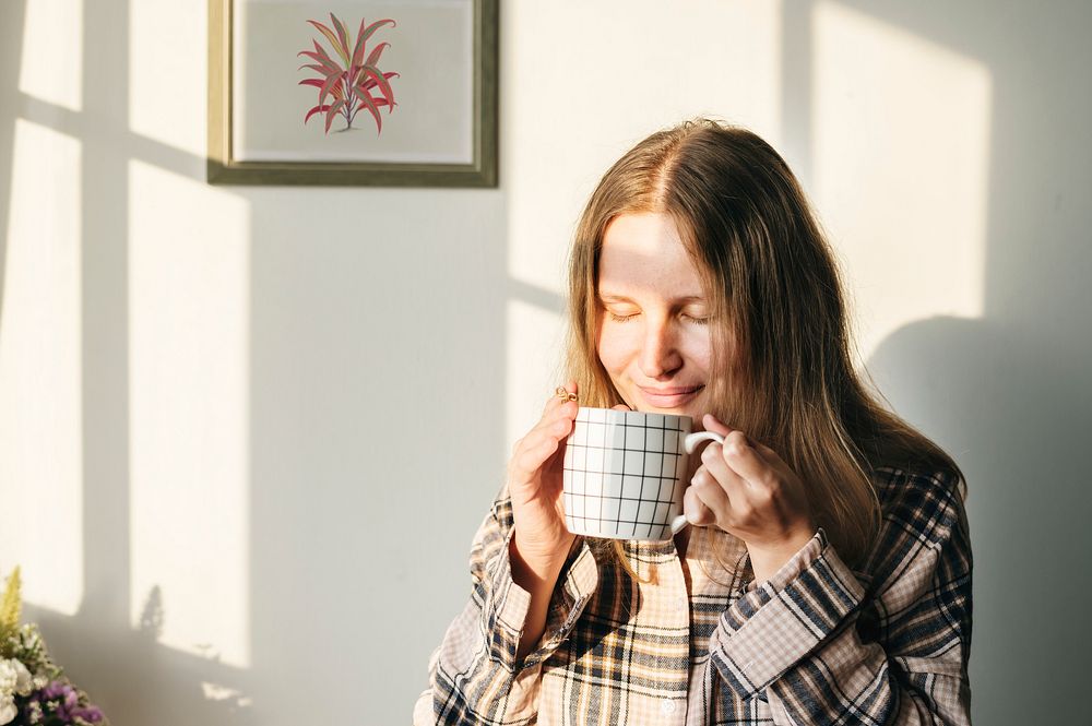 Caucasian woman drinks coffee in the morning