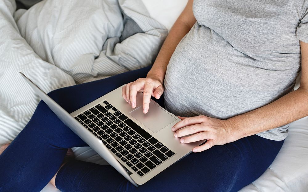 Pregnant woman using computer laptop