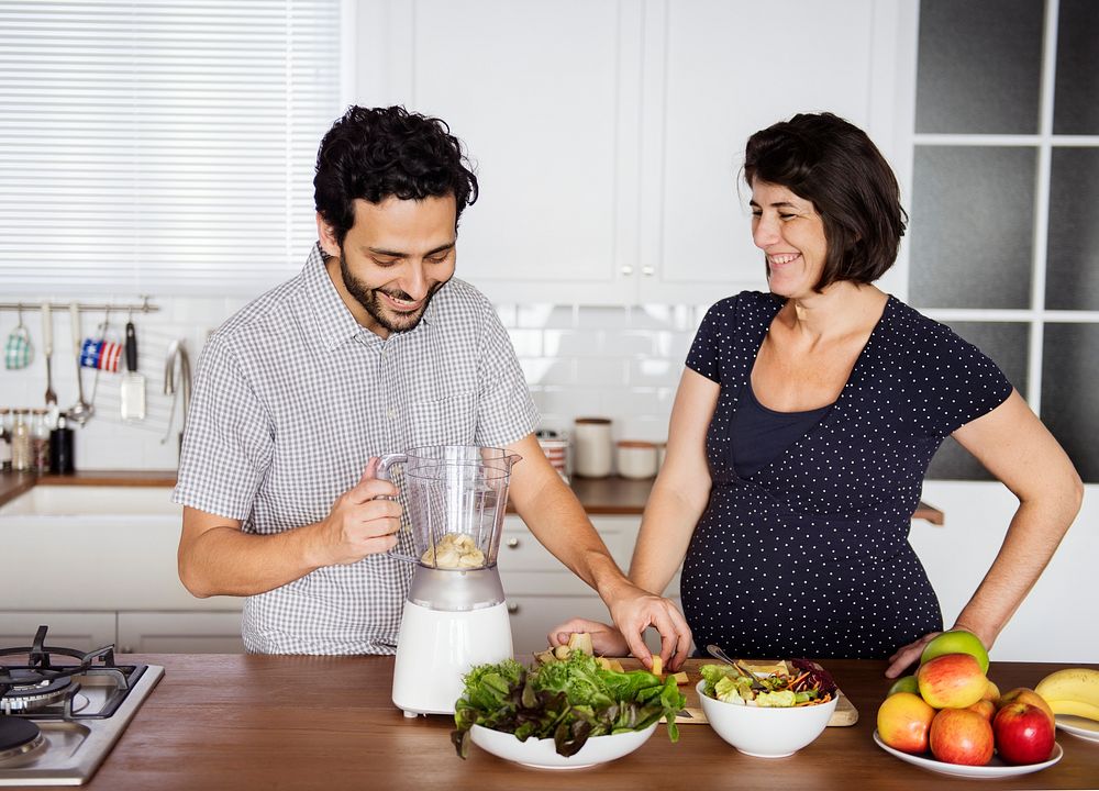 Caucasian couple making fresh smoothie