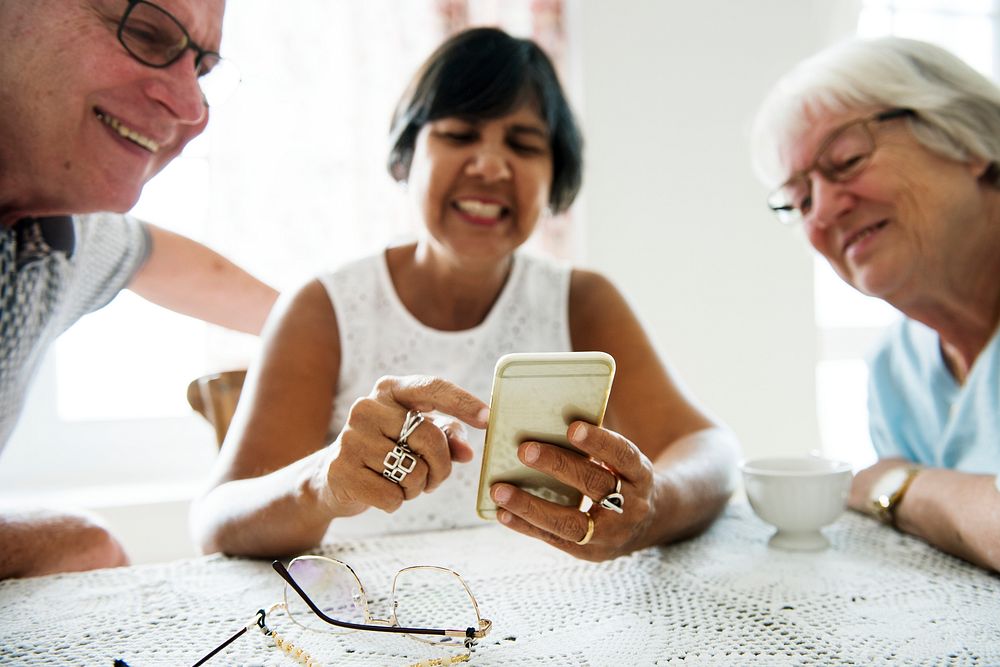 Group of diverse senior people using mobile phone