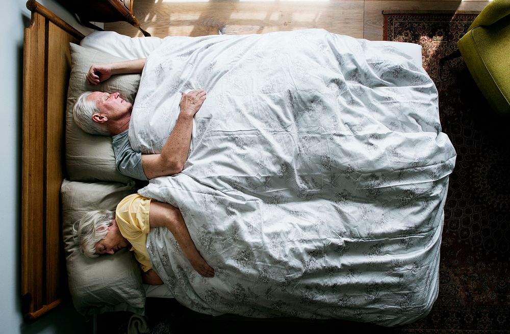 Elderly Caucasian couple sleeping