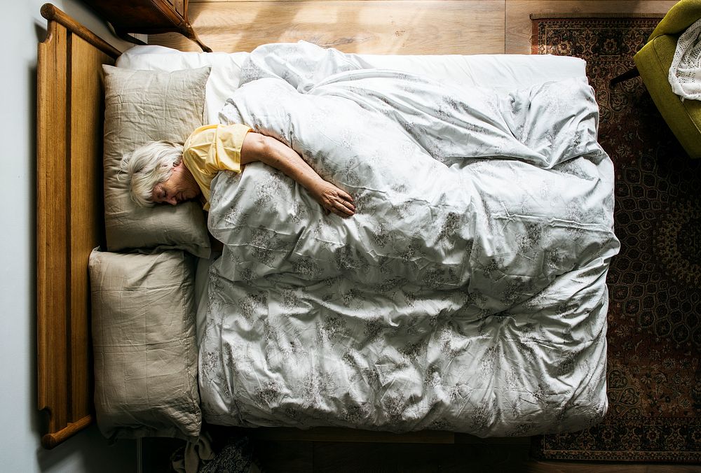 Elderly Caucasian woman sleeping on the bed