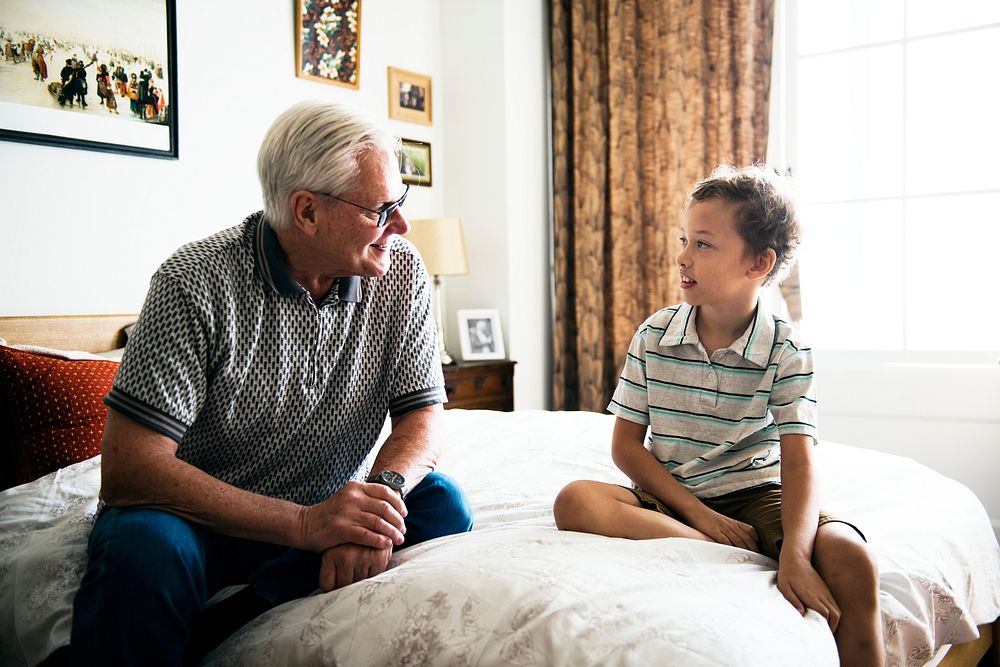 Grandpa and grandson sitting on the bed