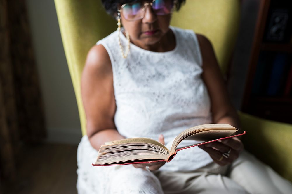 Senior woman reading book in the room