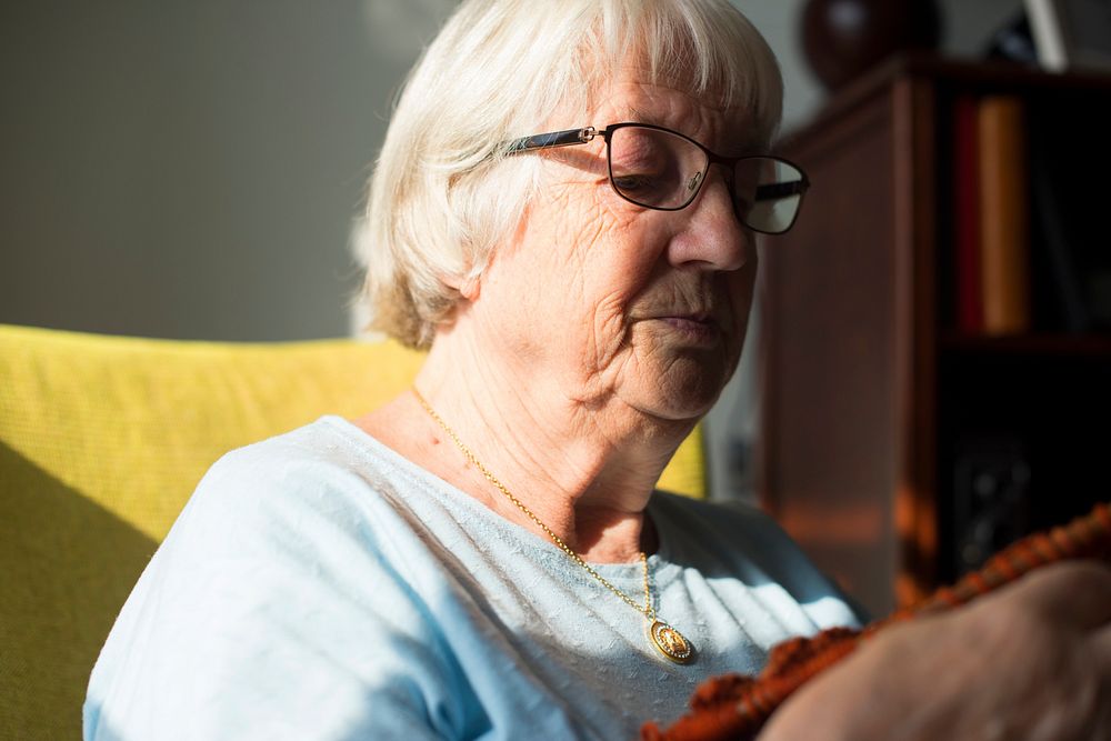 Senior woman knitting for hobby at home