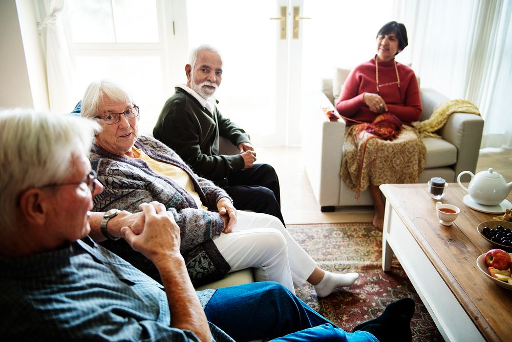 Senior people sitting together in a living room