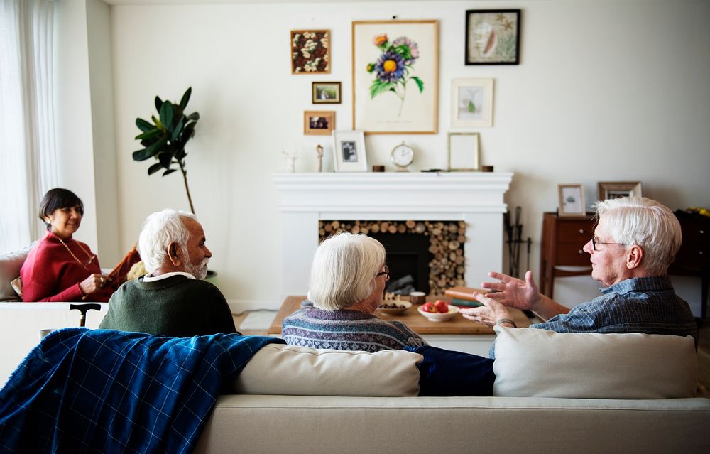 Senior people talking in a living room