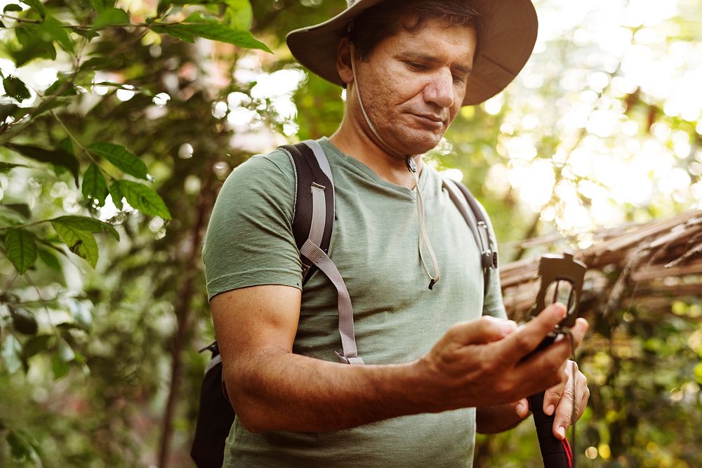 Man using mobile phone in a forest