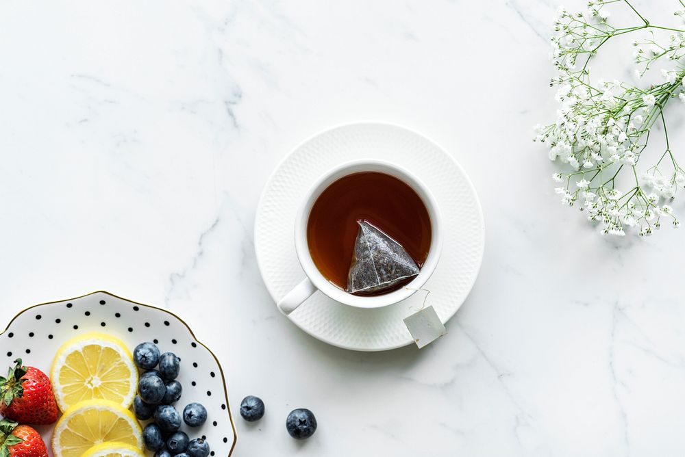 Aerial view of hot tea drink and fruits