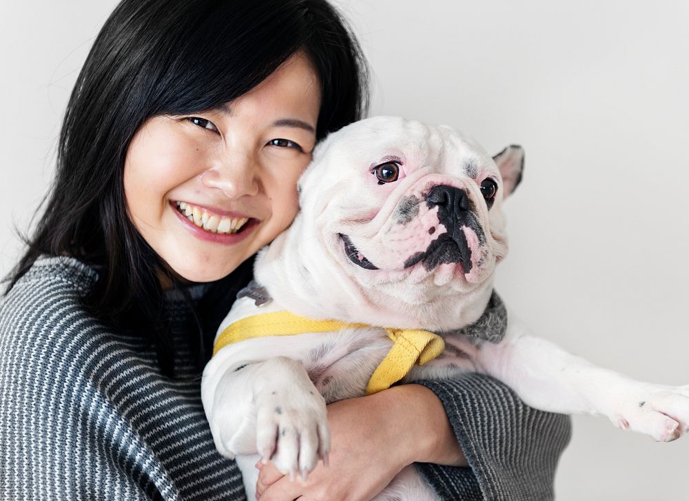 Asian woman hugging dog
